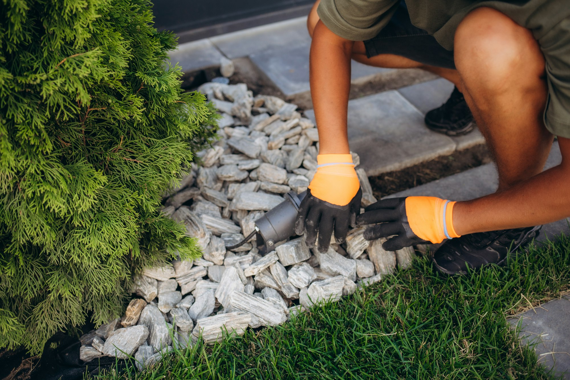 Decorative ground in the garden with artificial grass, gravel and explsed aggregate finish