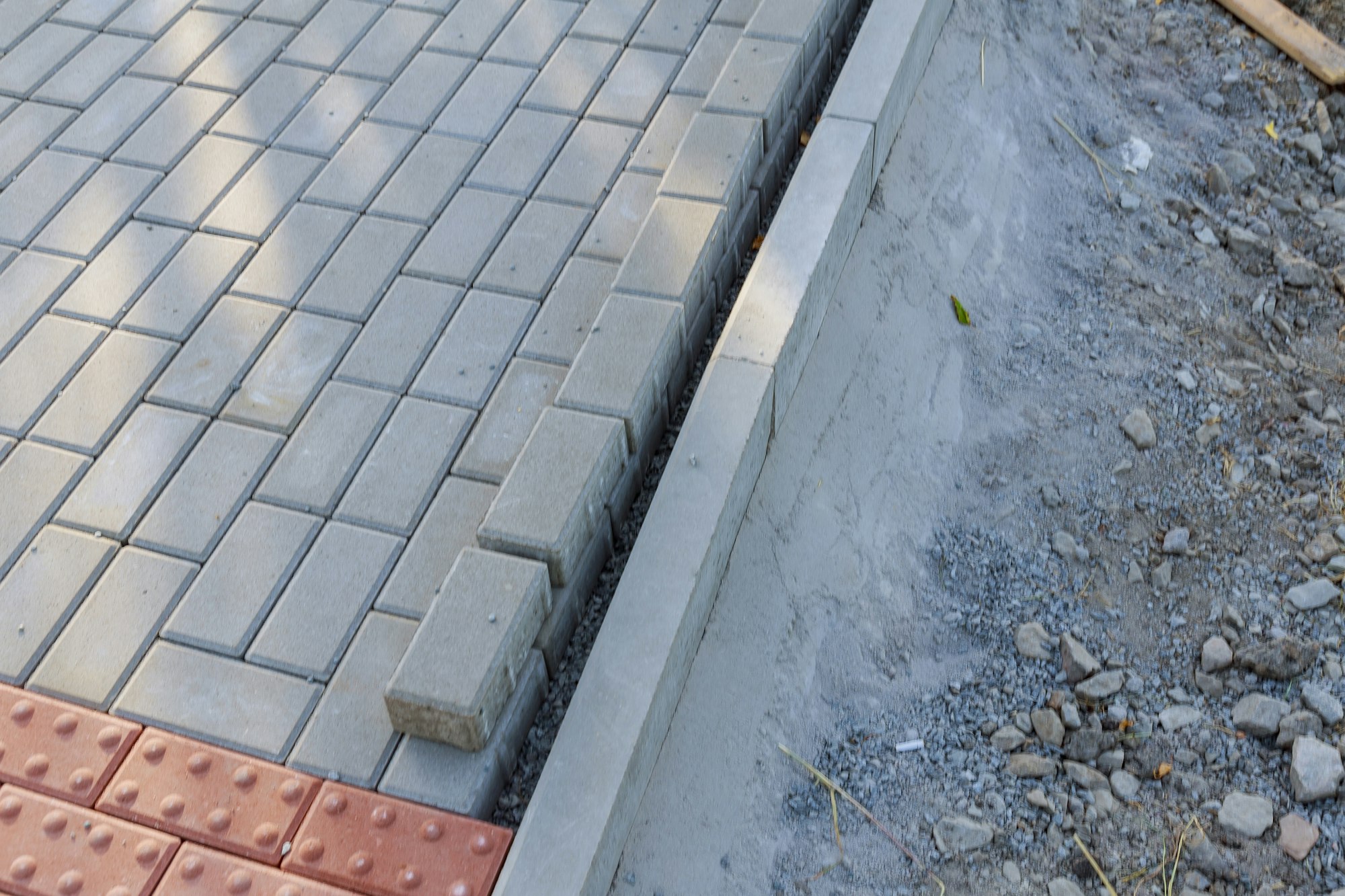 Laying paving stones on the footpath. Repair of pedestrian areas.