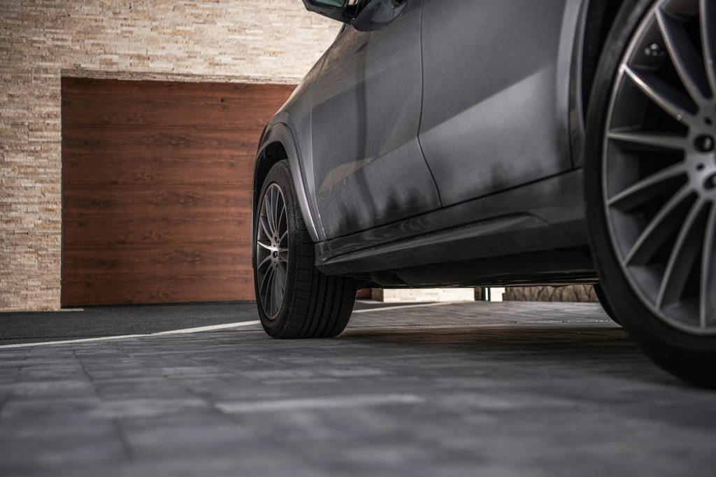 Modern Car on a Driveway in Front of Garage